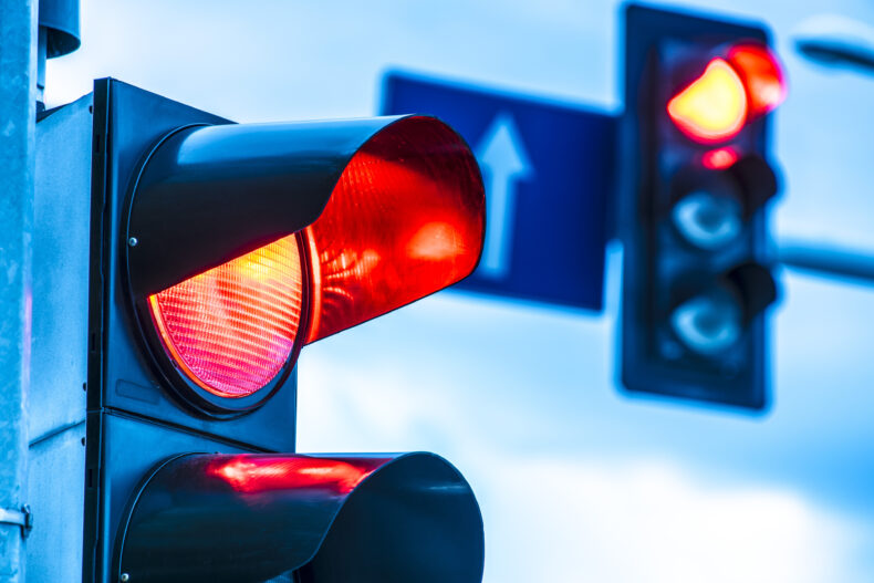 close up of red light at street intersection