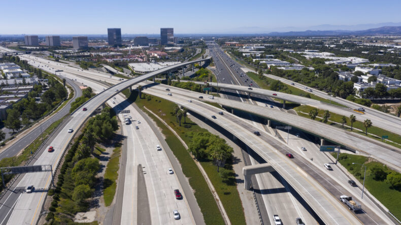 Daytime aerial view of the Irvine, California skyline and the 5 and 405 freeway interchange.