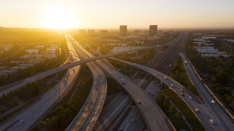 Sunset aerial view of Orange County skyline and the 5 and 405 freeway interchange