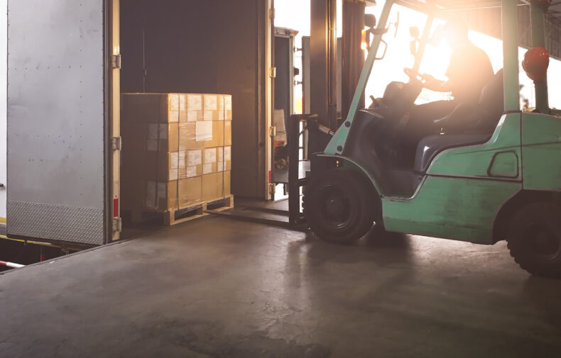 Forklift Tractor Loading Package Boxes into Cargo Container at Dock Warehouse. Delivery Service. Shipping Warehouse Logistics. Cargo Shipment. Freight Truck Transportation.