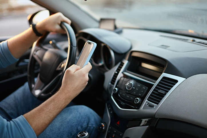 distracted drivers using cell phone behind the wheel
