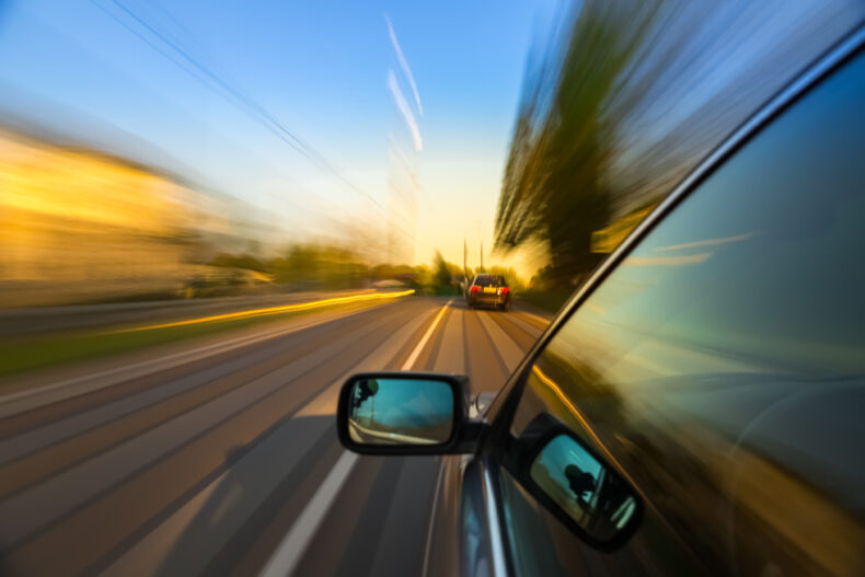 outside view of one car behind another car that is speeding away after a hit and run accident