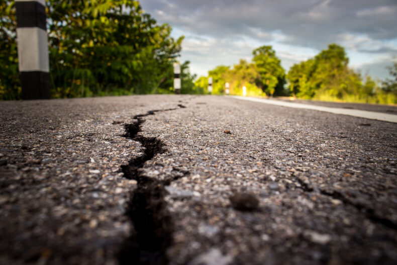 cracked road that has not been repaired by the city