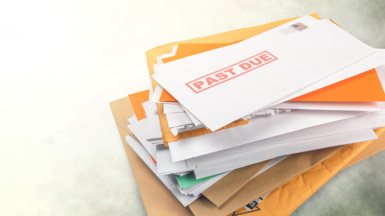 Pile of envelopes with overdue bills from medical debt