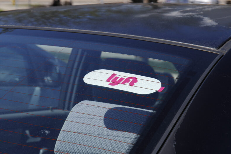 Car for hire with a Lyft sticker. Lyft and Uber have replaced many Taxi cabs for transportation with a smart phone app.