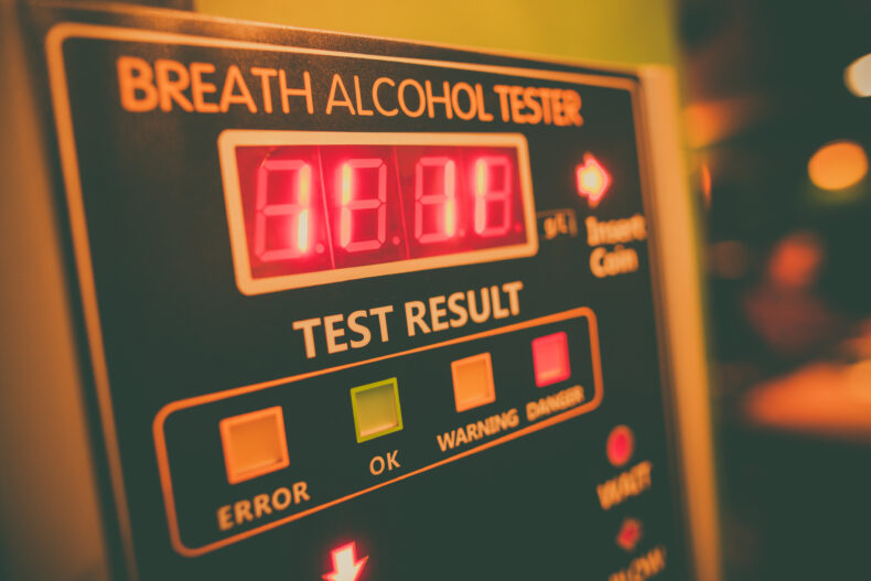 Close up shot of an alcohol tester on a wall.
